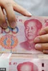 A clerk counts cash at a bank in Nantong, Jiangsu province